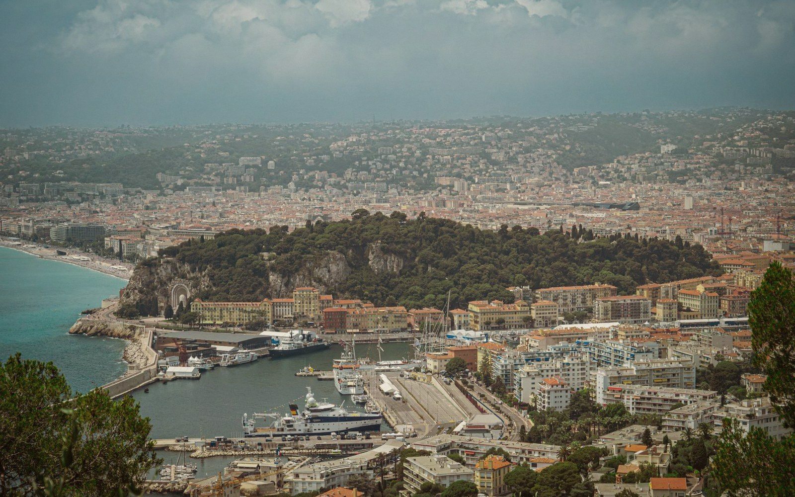 Aerial view of Nice harbor and coastline with Castle Hill separating the port from the beach